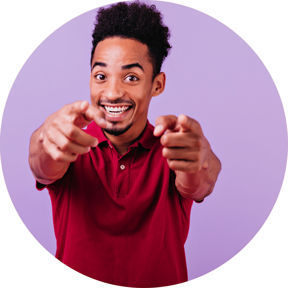 Inspired african guy pointing finger to camera  Studio shot of laughing positive black man smiling on purple background 